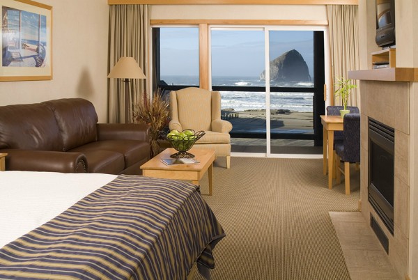 Inn at Cape Kiwanda Room with bed and Haystack rock outside the window